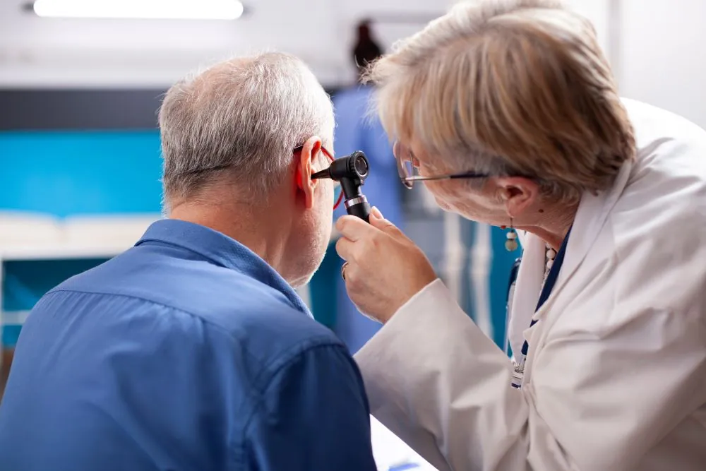 Man getting his ears examined with an otoscope