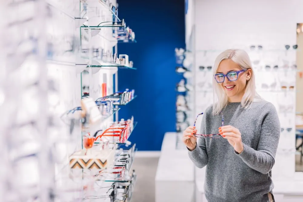 Woman looking at glasses in an opticians shop