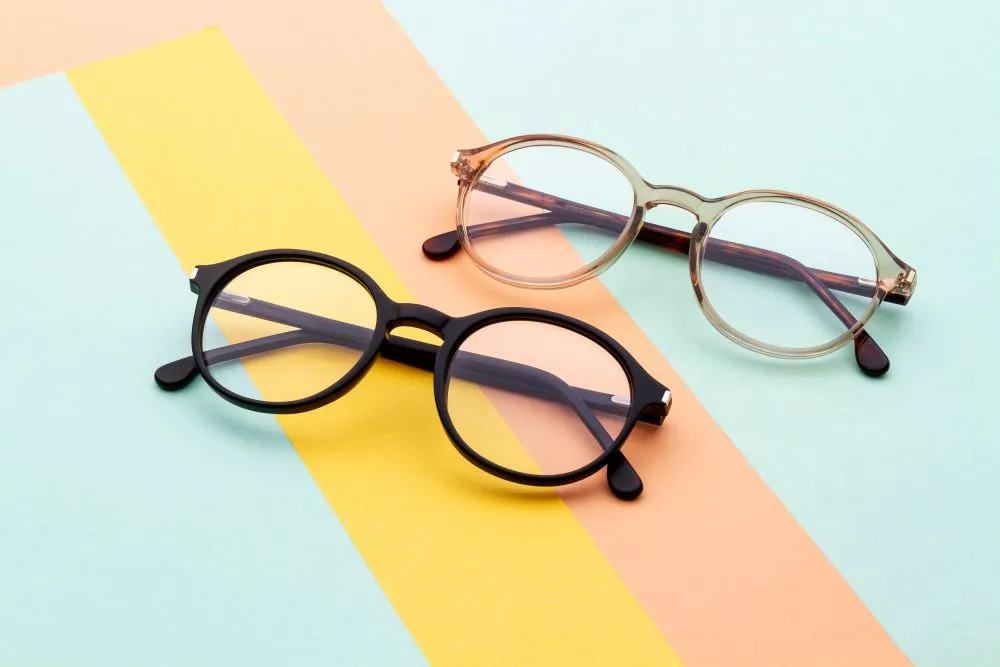 two pairs of glasses on a colourful background