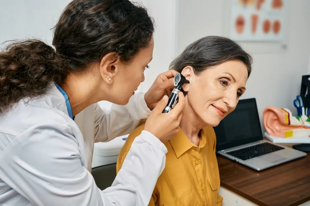 Audiologist conducting a hearing exam on woman
