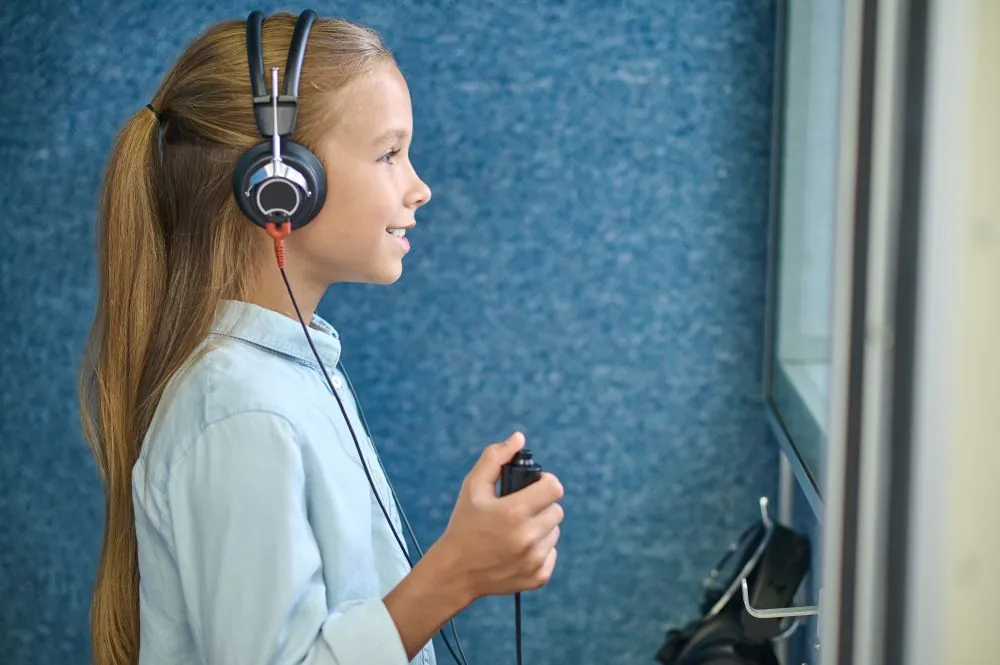 Girl in headphones taking an audiometric test