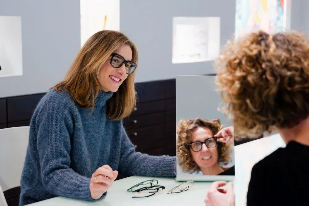 Optician helping a woman choosing glasses